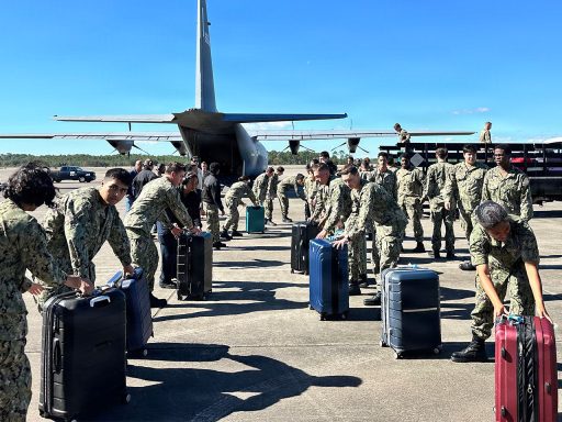 service members transport luggage