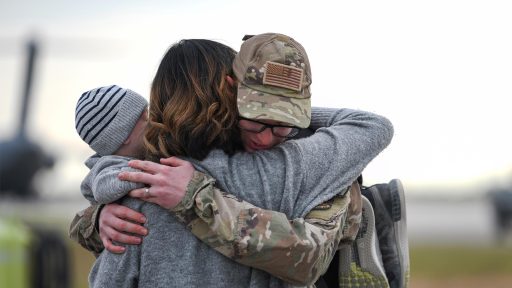 soldier hugs family