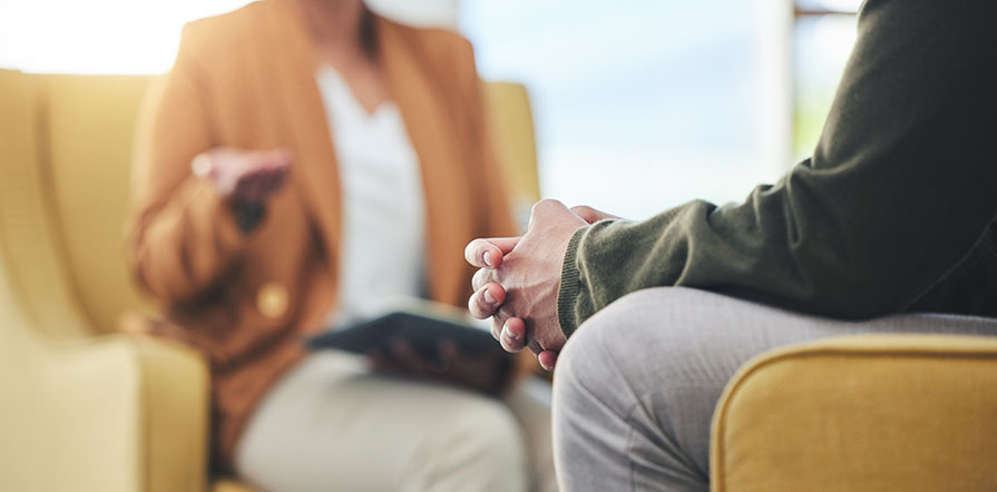 man speaking with counselor
