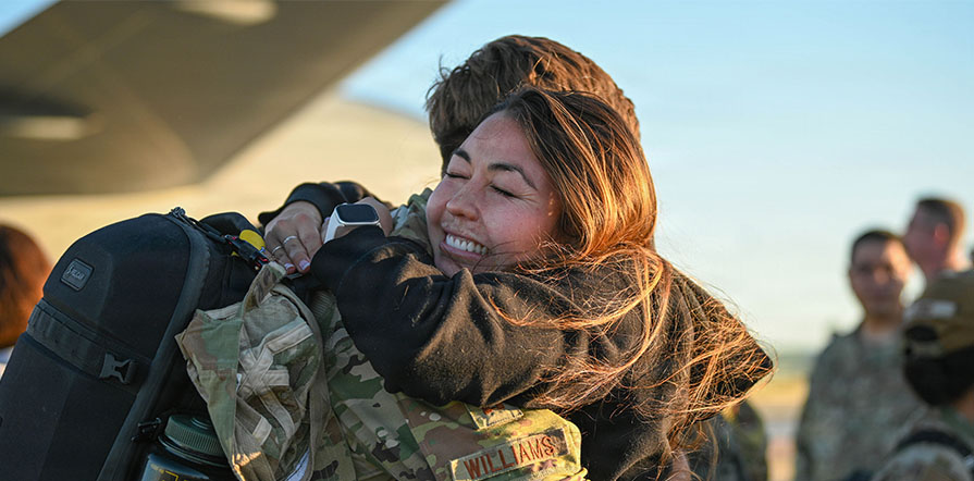 service member hugs loved one
