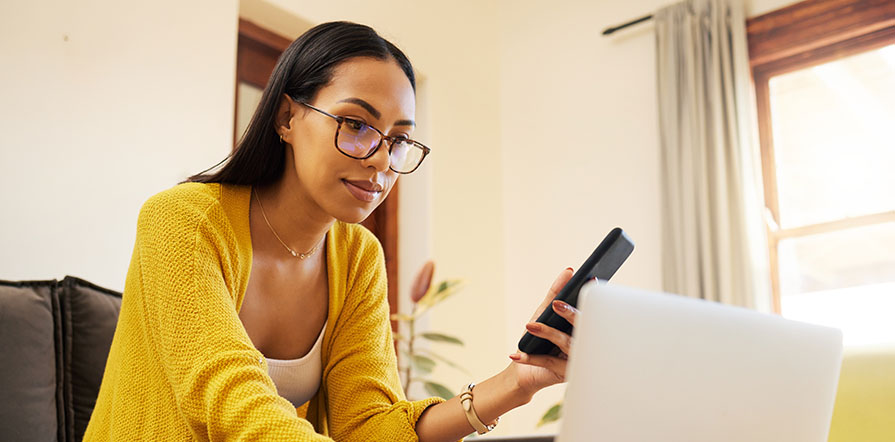 woman on computer and phone