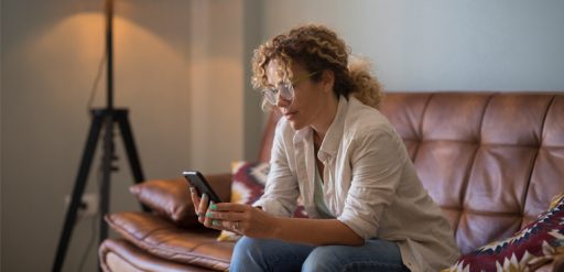 young woman text messaging using mobile phone