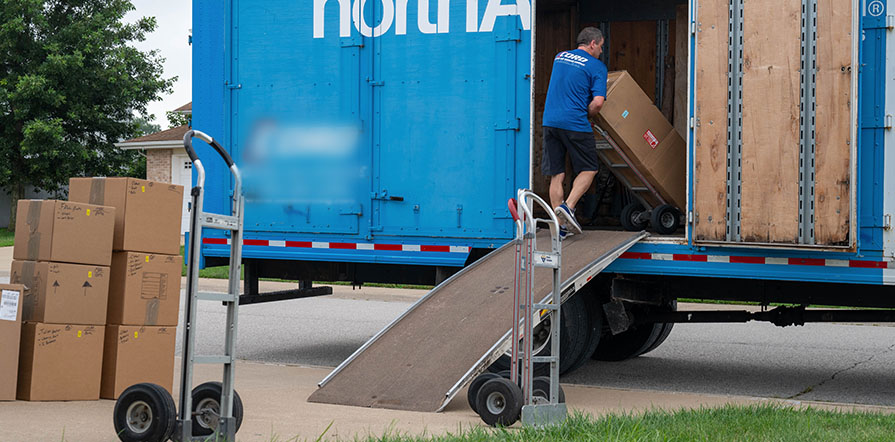 household goods being loaded into a moving truck during a PCS move