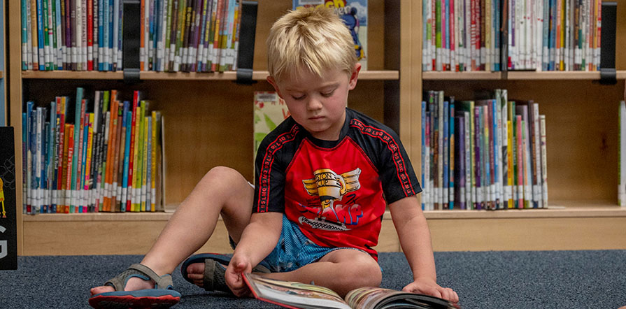 child reading in library