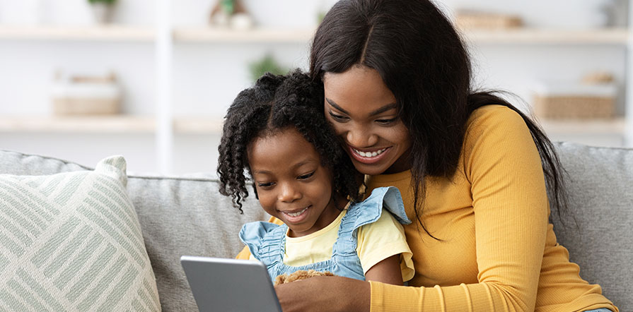 mother and daughter video chatting with loved one