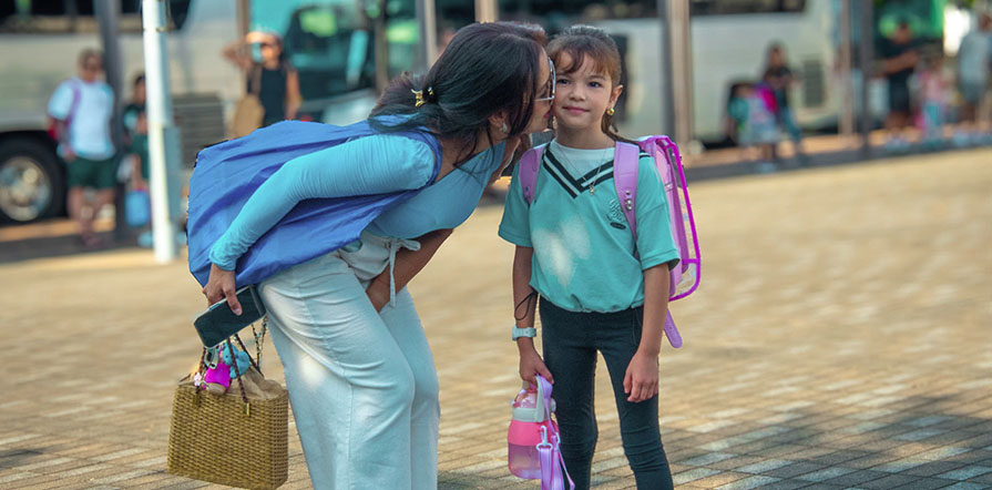 mother dropping child off at school