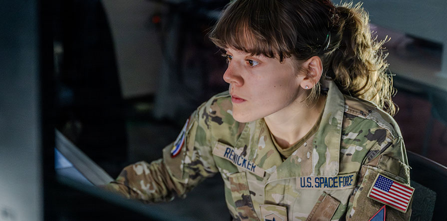 service member looking at computer