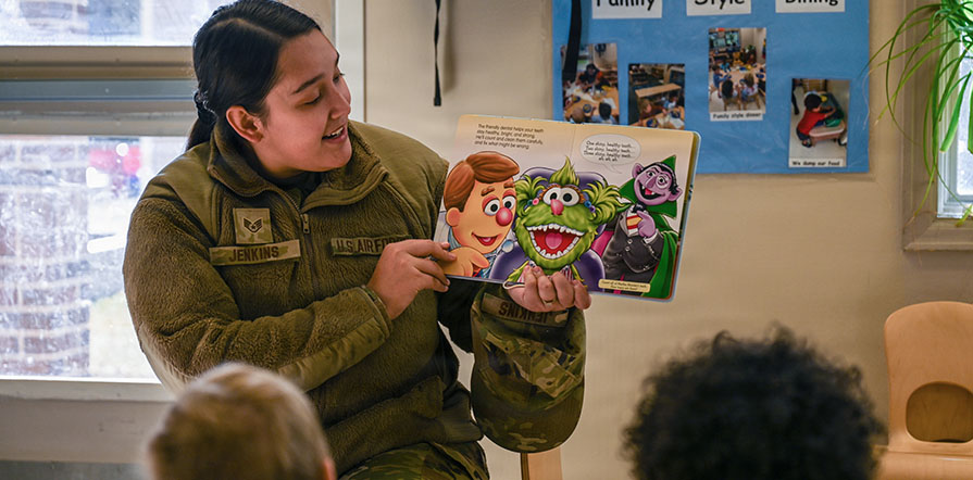 service member reads to children