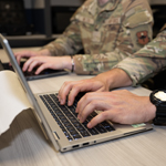 Service member working on a laptop