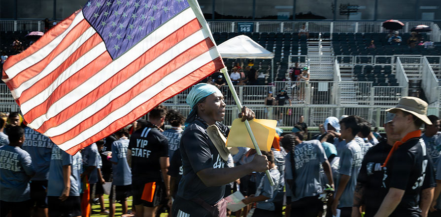 person carrying American flag