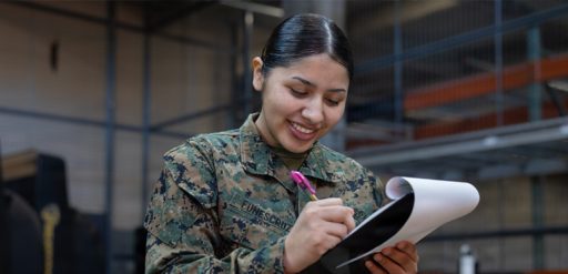service member writing on notepad