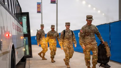 Service members getting off a bus