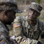 chaplain speaking to service member in the field