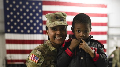 National guard service member posing with son