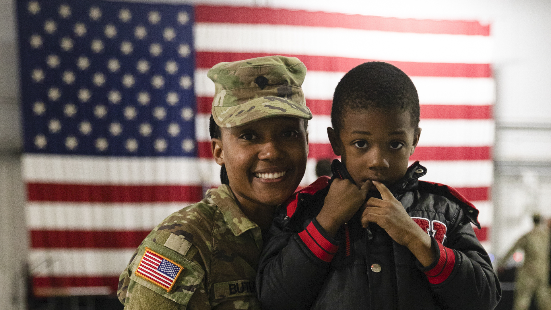 National guard service member posing with son