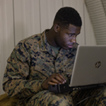 service member working on laptop