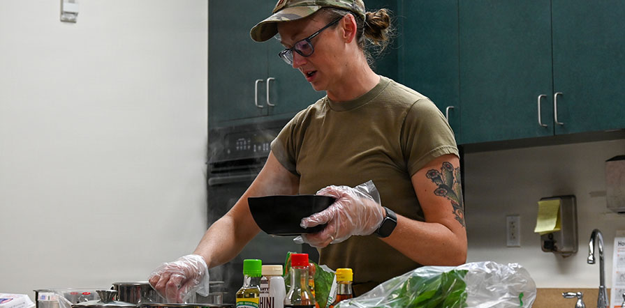 service member leads cooking class
