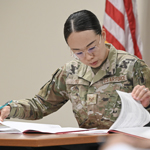 service member working on financial documents