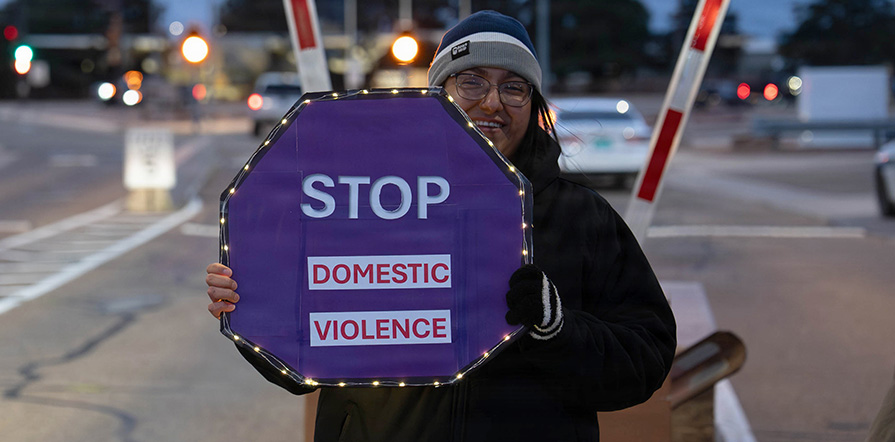 woman holding stop domestic abuse sign