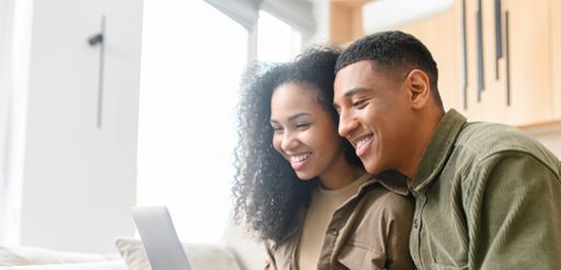man and woman working on laptop
