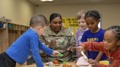 Service member teaching children in a child development center