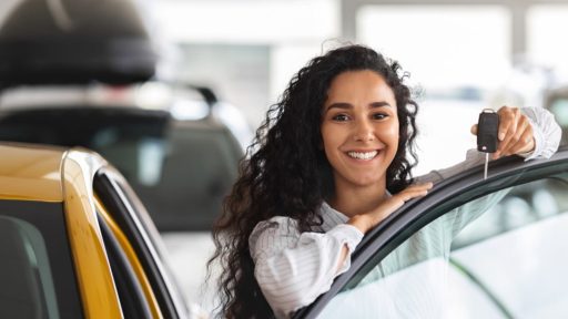 Woman getting into new car